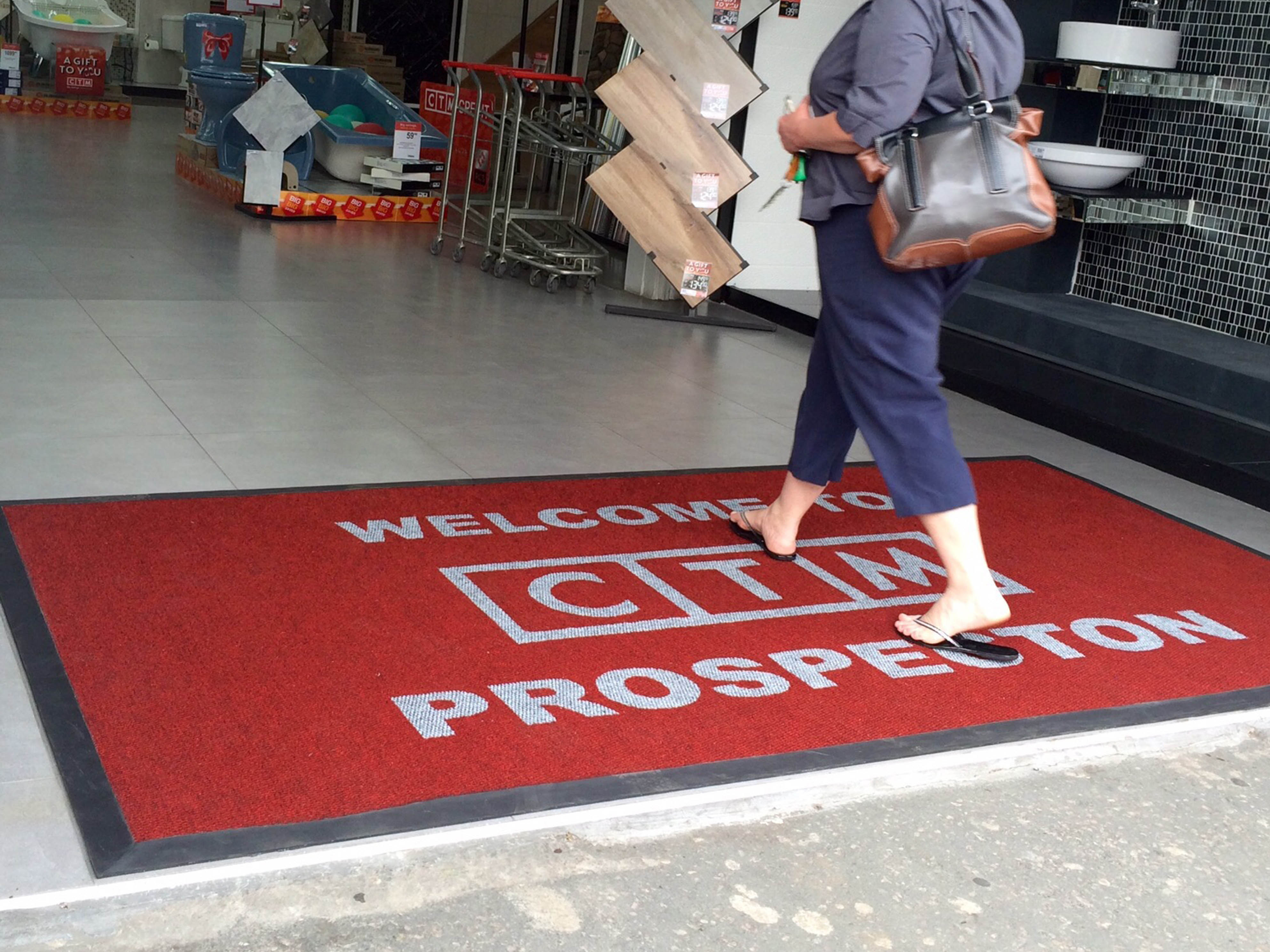 Vibrant custom branded mat at a South African business entrance